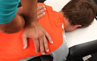 Man laying on an adjustment table receiving adjustment