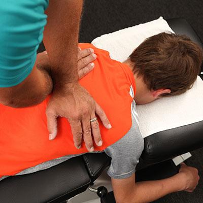 Man laying on an adjustment table receiving adjustment