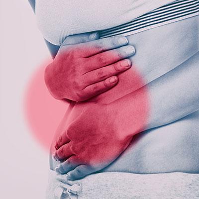 Person holding gut in pain from IBS