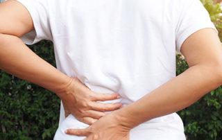 Person holding back in pain