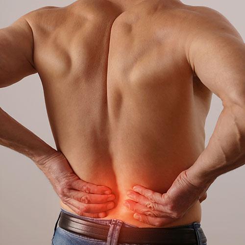 man holding back in pain