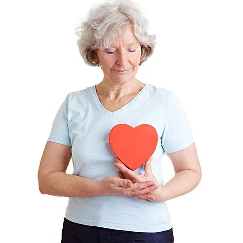 Woman holding paper heart for heart health