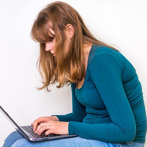 woman with poor posture on laptop
